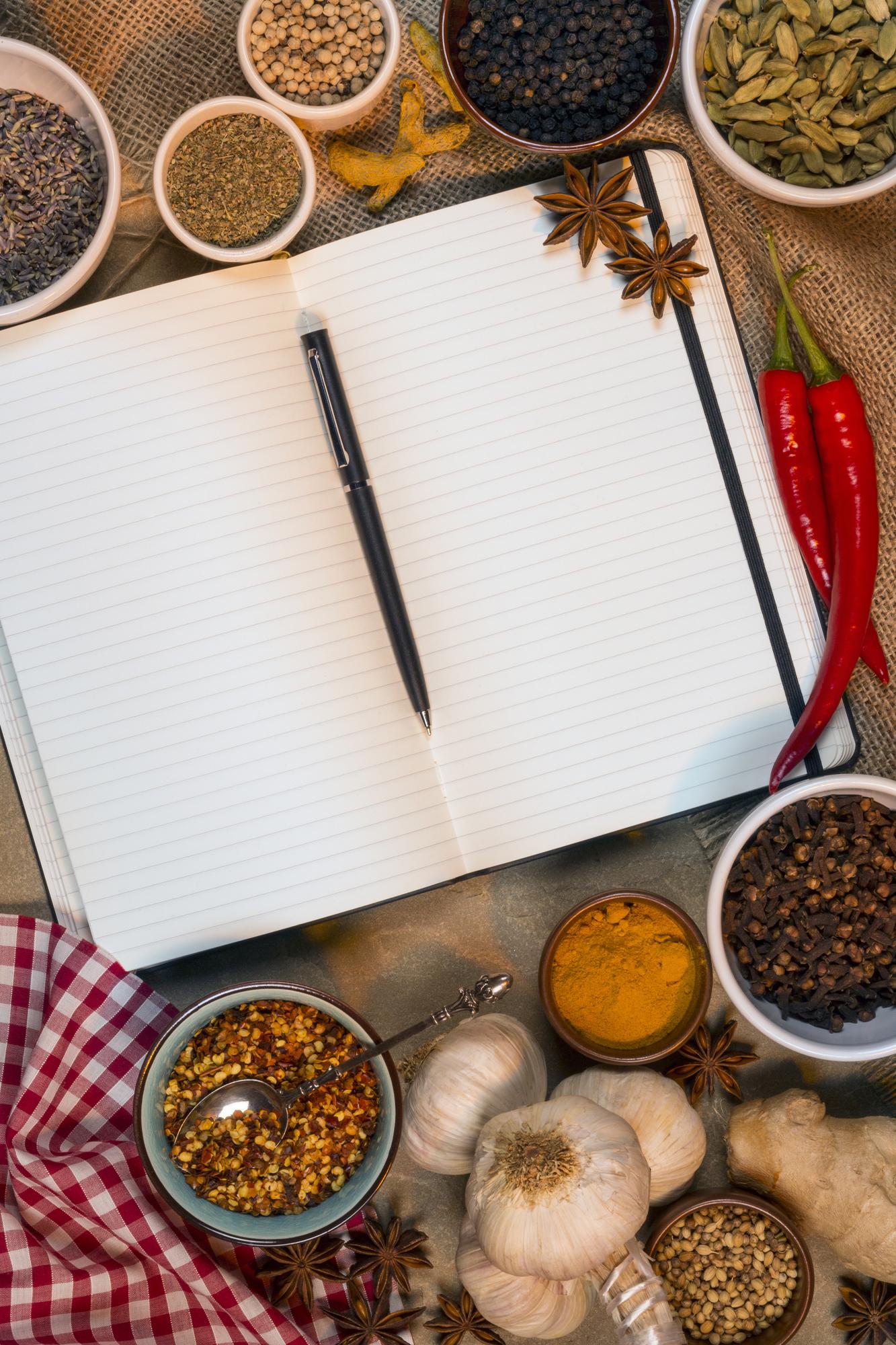 Workshop table with spices, handwritten recipe and utensils
